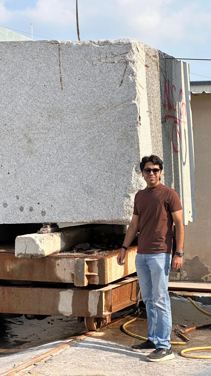 A quarried stone block being inspected at the processing yard